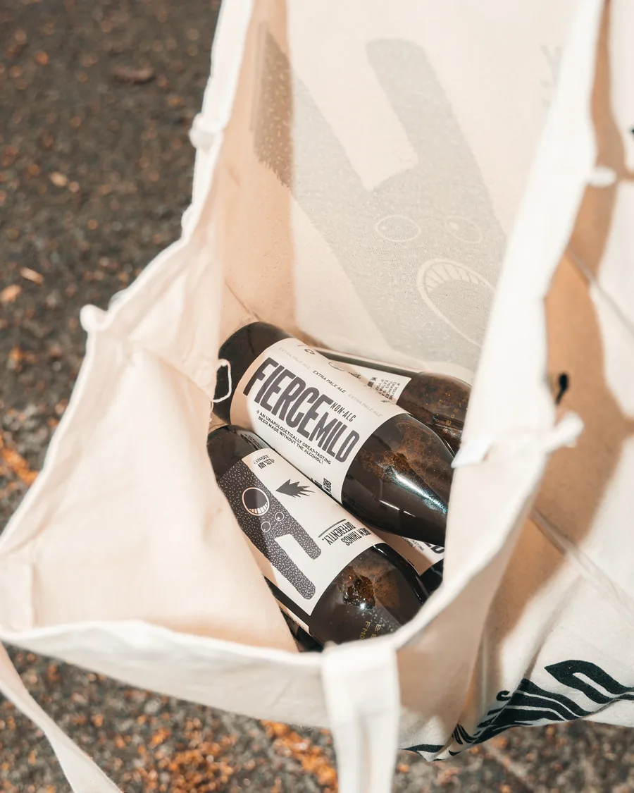 An open Fierce Mild tote bag with bottles inside